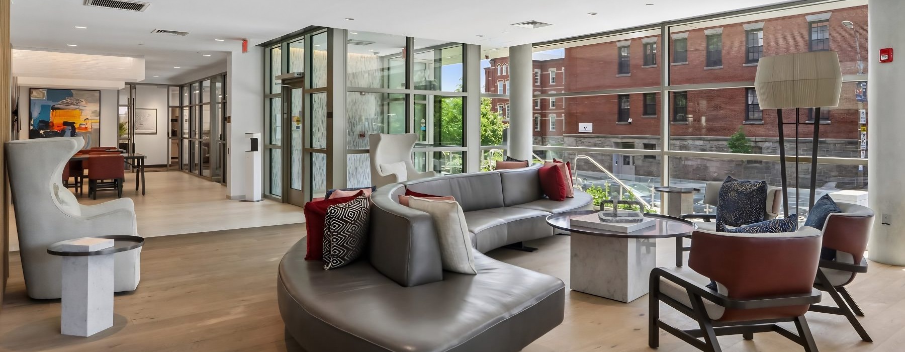 a clubroom with a couch, tables and chairs
