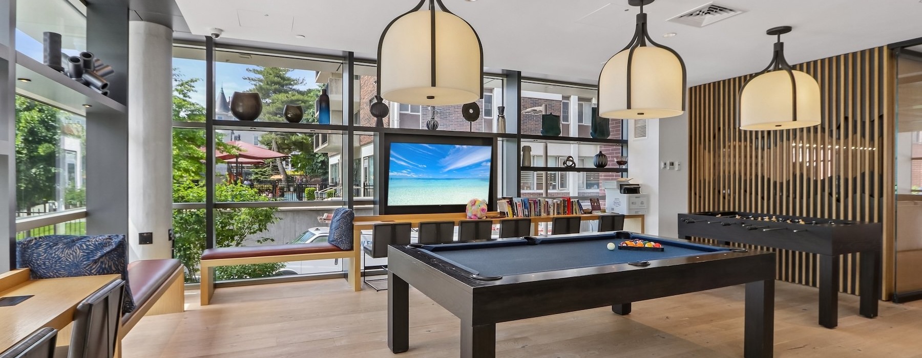 a game room with pool tables and a tv
