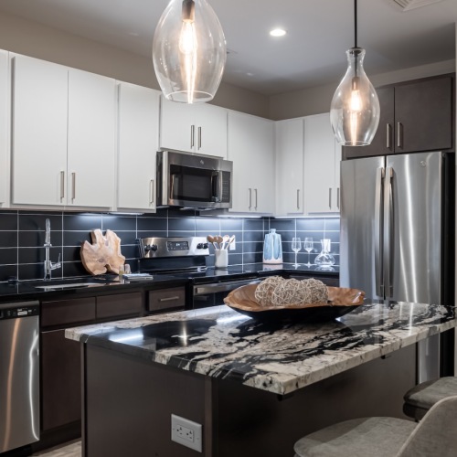 a kitchen with an island and chairs